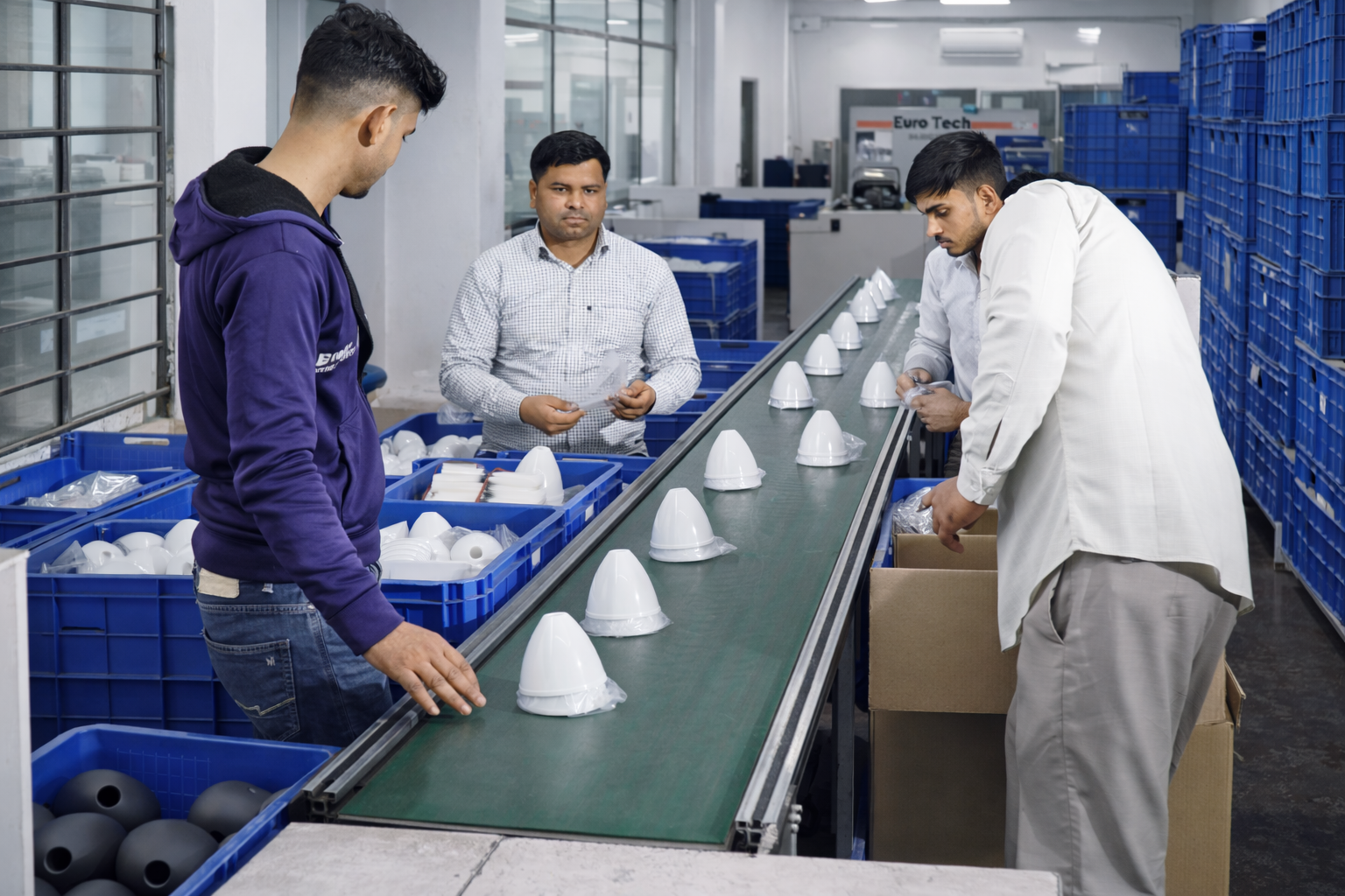 Plastic injection molding production line with workers inspecting molded parts